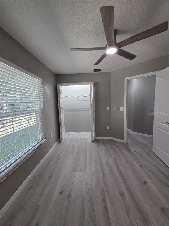 Undisclosed Address Spring Hill, FL 34609 - Photo 34 of 50 wooden floor in an empty room with a window