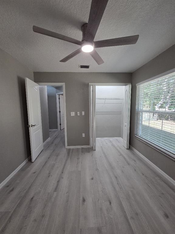 Undisclosed Address Spring Hill, FL 34609 - Photo 39 of 50 an empty room with wooden floor and windows