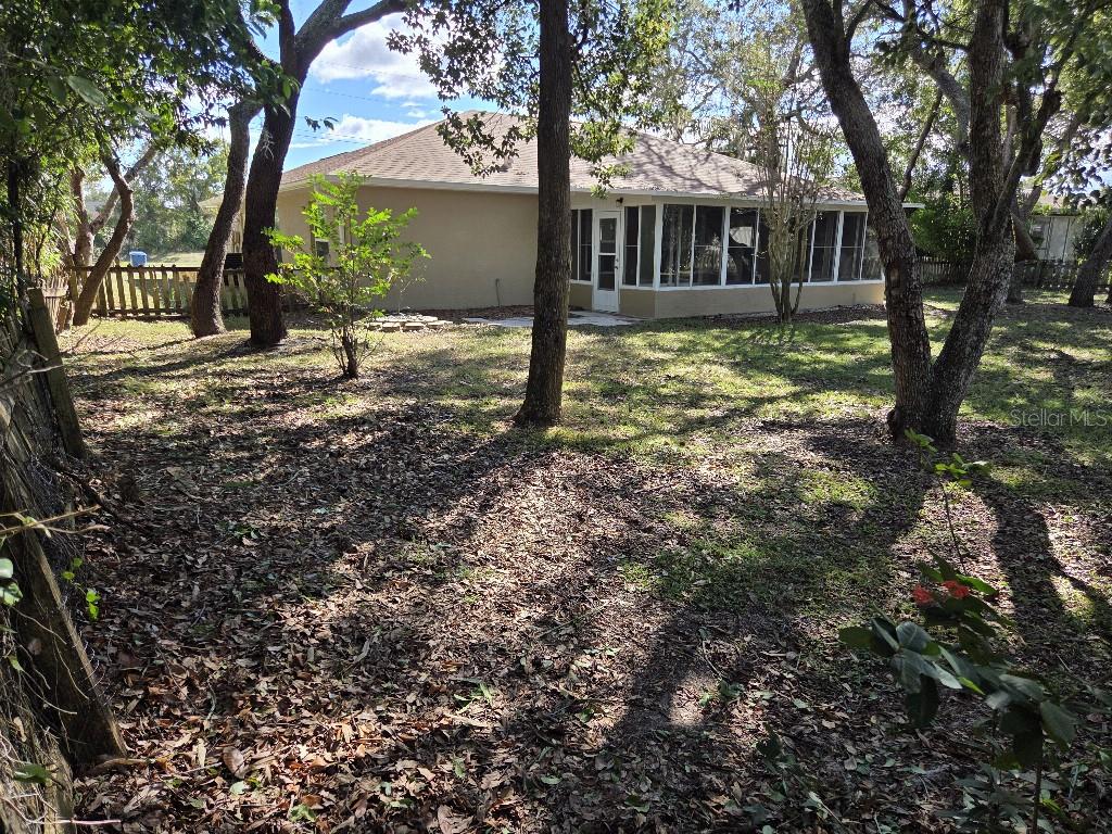 Undisclosed Address Spring Hill, FL 34609 - Photo 46 of 50 a view of a house with backyard and tree