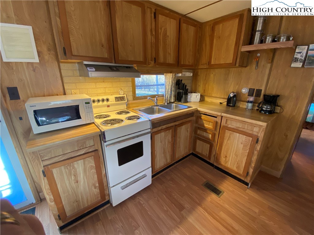 252 Jameson Road Newland, NC 28657 - Photo 7 of 16 a kitchen with a stove sink and cabinets