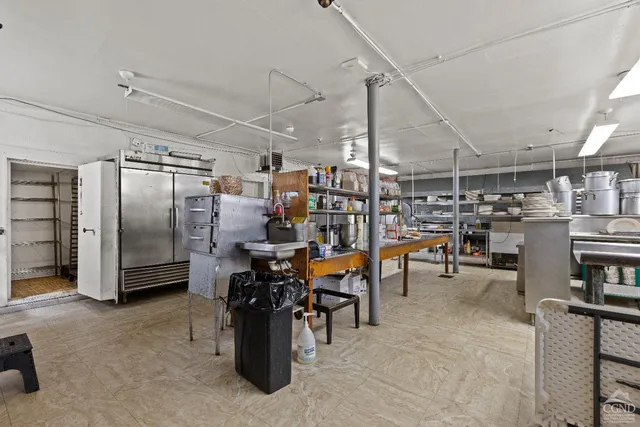 a bedroom with a bed couch and a window