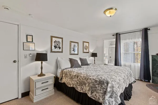 a bedroom with a bed and large mirror