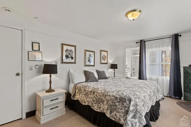 a bedroom with a bed and large mirror