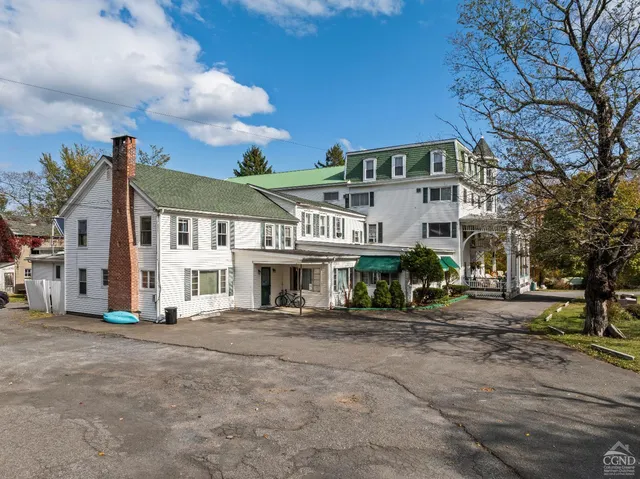 a view of a yard with an ocean & house
