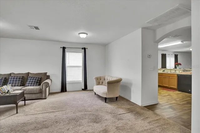 a kitchen with stainless steel appliances granite countertop a sink stove and wooden floor