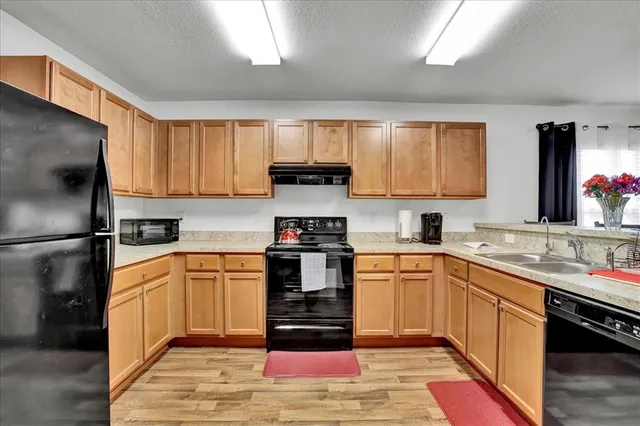 a view of a dining room with furniture and a kitchen