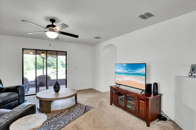 a view of a room with furniture and floor to ceiling window