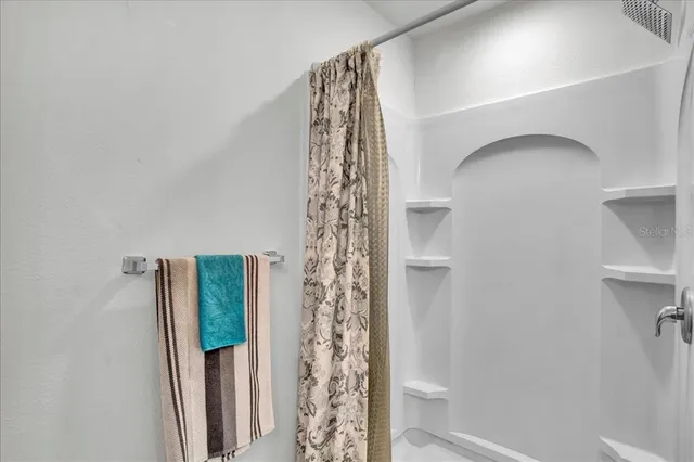 a bathroom with a shower curtain and a toilet