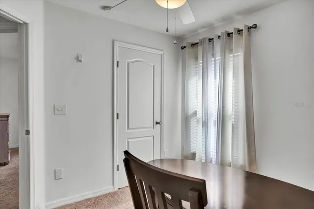 an empty room with closet and chandelier fan