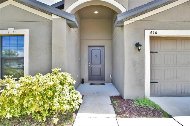 a view of a house with a yard and garage