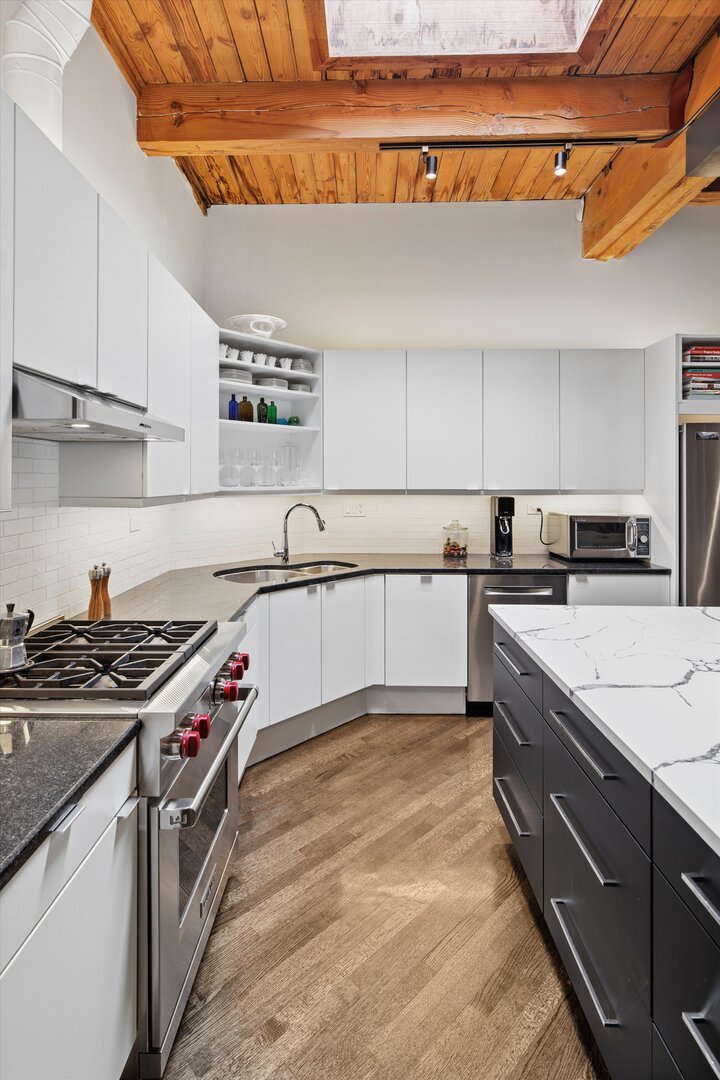 2222 North Racine Avenue, Unit 16 Chicago, IL 60614 - Photo 10 of 32 a kitchen with granite countertop a sink a stove and cabinets