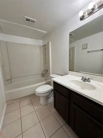 a bathroom with a double vanity sink toilet and shower