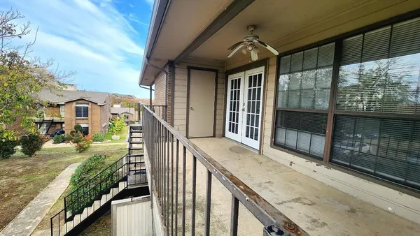 a backyard of a house with table and chairs