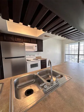 a kitchen with a sink a stove and refrigerator