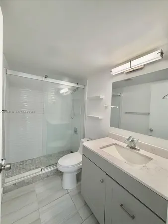 a bathroom with a sink toilet and shower
