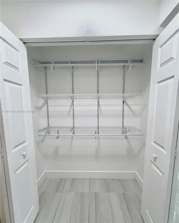 a view of walk in closet with empty racks