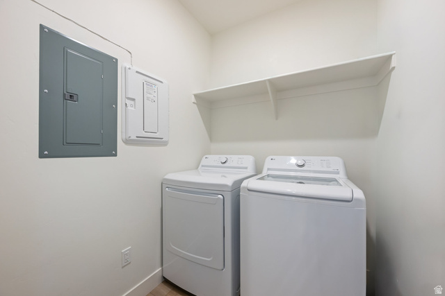 762 West Periwinkle Lane, Unit 102 St. George, UT 84790 - Photo 25 of 40 Laundry area with electric panel and washing machine and clothes dryer