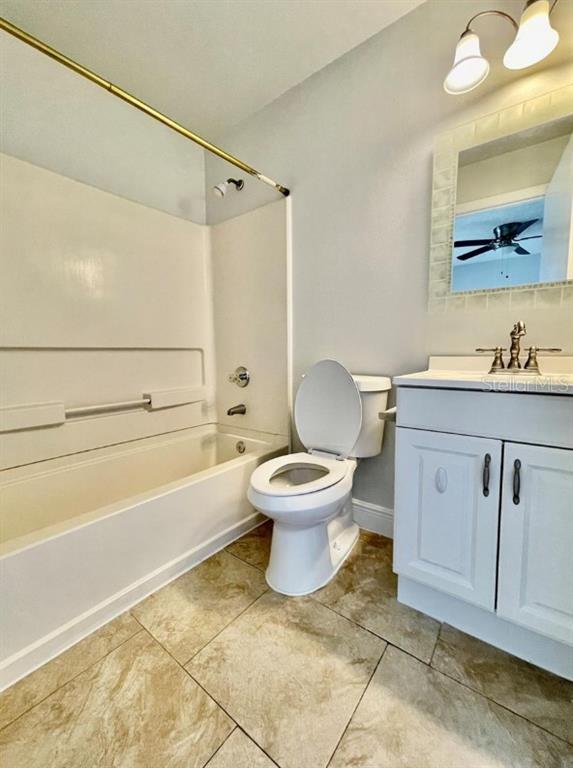 3651 North Goldenrod Road, Unit D201 Winter Park, FL 32792 - Photo 11 of 12 a bathroom with a toilet sink and mirror