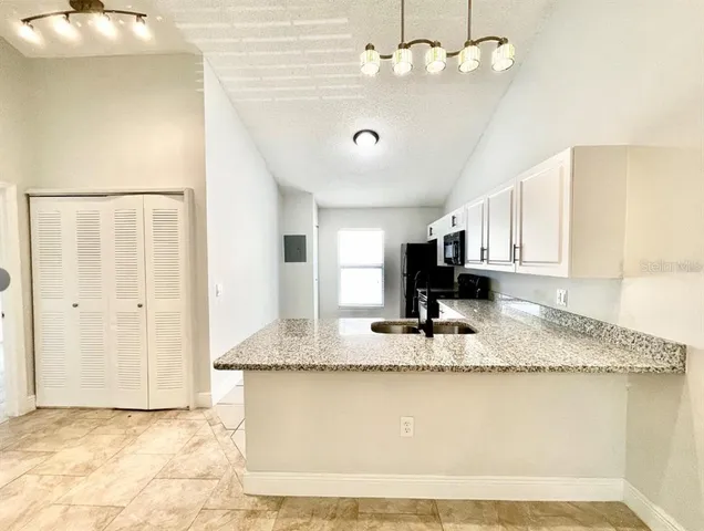 a kitchen with a sink cabinets and appliances