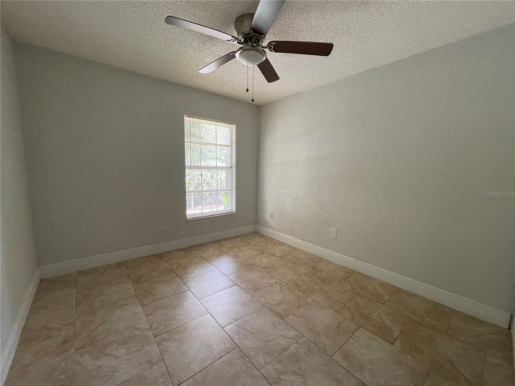 3651 North Goldenrod Road, Unit D201 Winter Park, FL 32792 - Photo 10 of 12 an empty room with a window and a fan