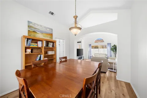 a dining room with wooden floor and breakfast area