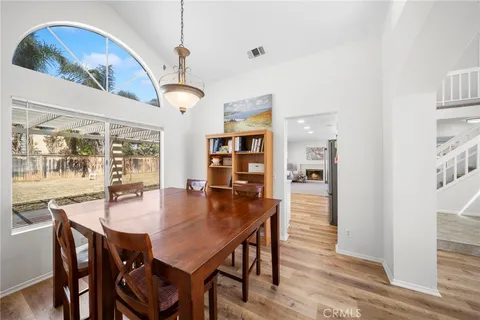 a large white kitchen with a stove a sink and dishwasher with wooden floor
