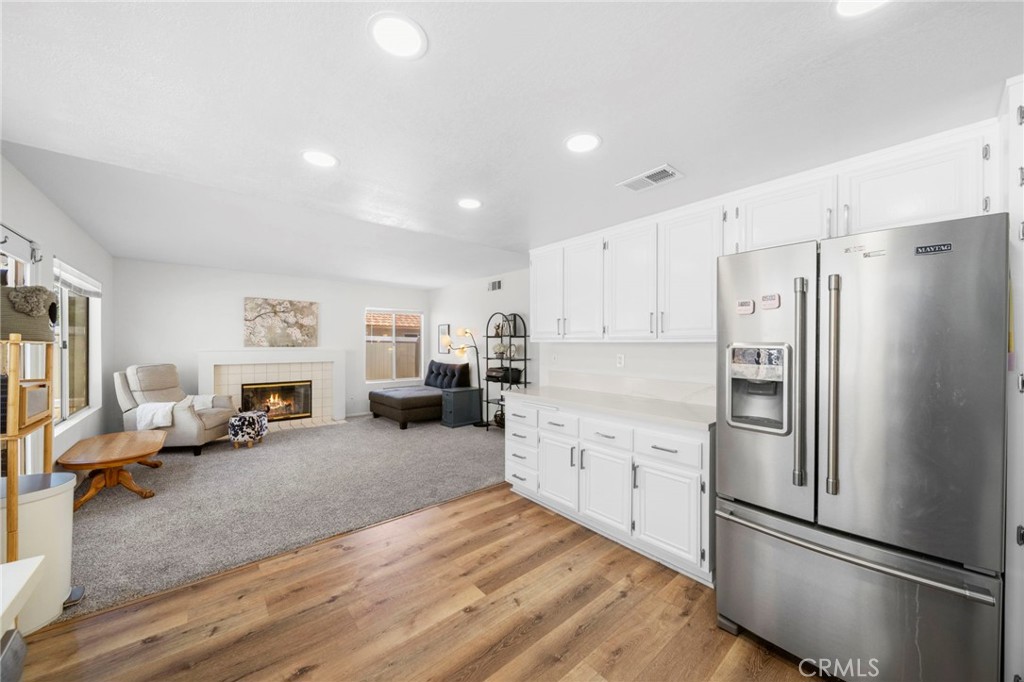 9253 Sunridge Drive Riverside, CA 92508 - Photo 20 of 57 a large kitchen with stainless steel appliances refrigerator a stove and cabinets