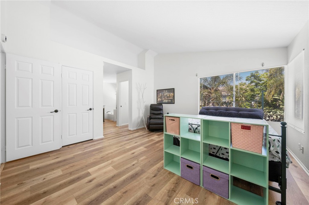 9253 Sunridge Drive Riverside, CA 92508 - Photo 26 of 57 a view of an empty room with window and wooden floor