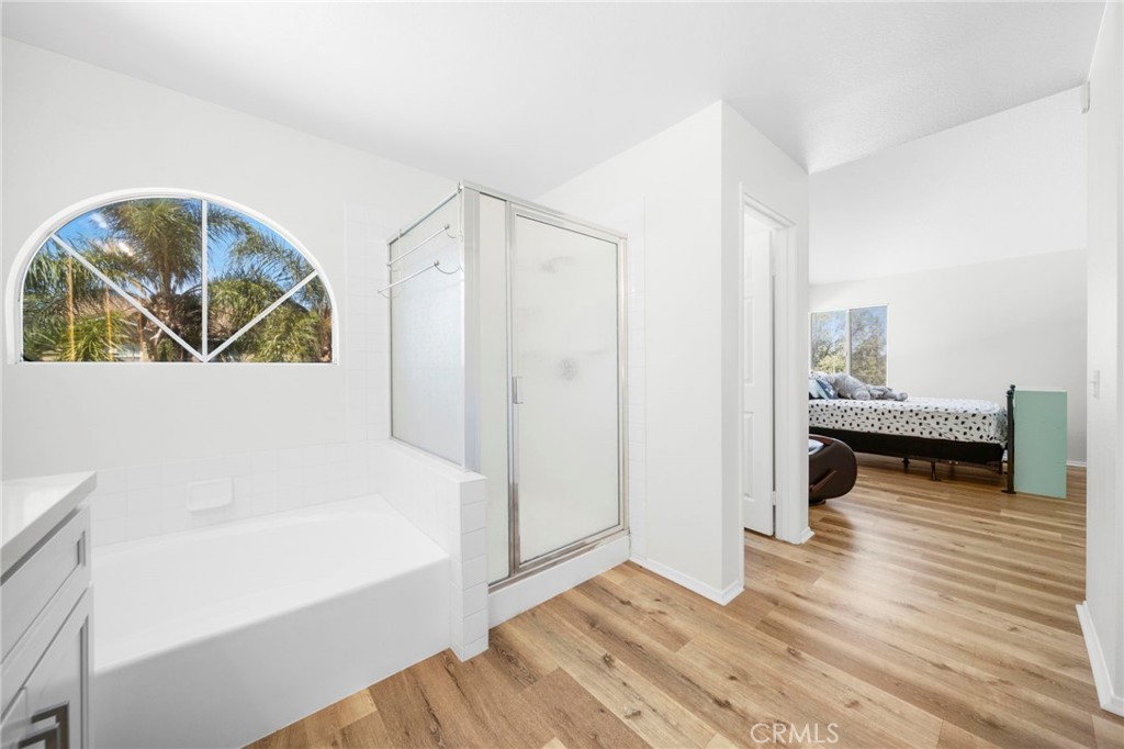 9253 Sunridge Drive Riverside, CA 92508 - Photo 28 of 57 a view of a bedroom with wooden floor and windows