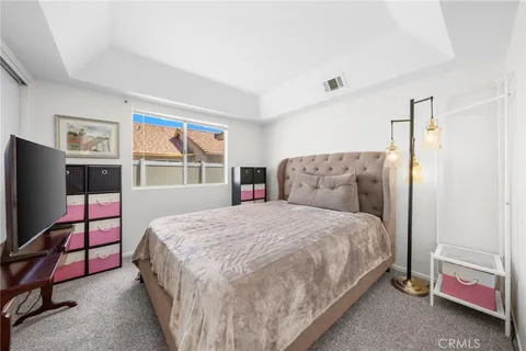 a bedroom with furniture and a flat screen tv