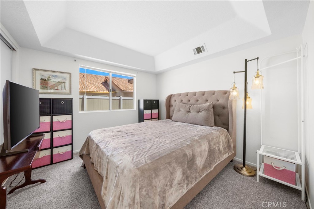 9253 Sunridge Drive Riverside, CA 92508 - Photo 30 of 57 a bedroom with a bed and a flat screen tv