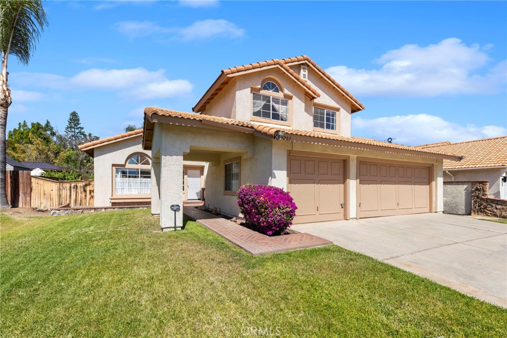 9253 Sunridge Drive Riverside, CA 92508 - Photo 3 of 57 a front view of a house with a garden and deck