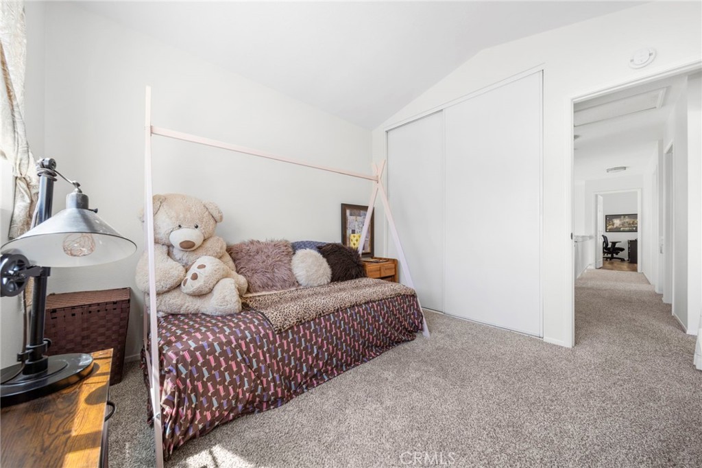 9253 Sunridge Drive Riverside, CA 92508 - Photo 35 of 57 a living room with furniture a flat screen tv and a mirror