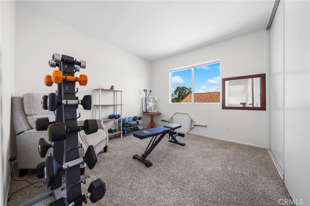 9253 Sunridge Drive Riverside, CA 92508 - Photo 40 of 57 a living room with furniture and a gym machine