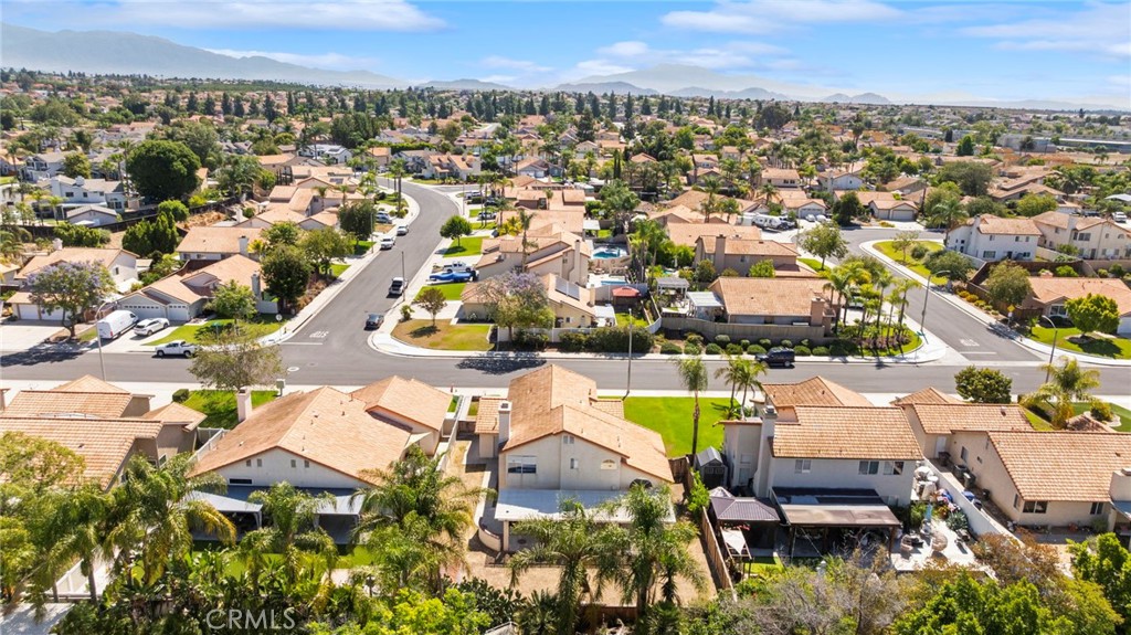 9253 Sunridge Drive Riverside, CA 92508 - Photo 55 of 57 an aerial view of a house with a swimming pool yard and mountain view in back