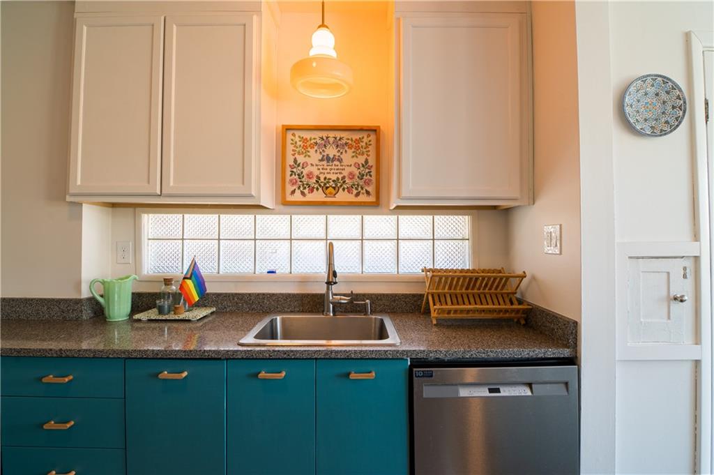 6673 Kinsman Road Pittsburgh, PA 15217 - Photo 12 of 50 a kitchen with stainless steel appliances granite countertop a sink and a white cabinets