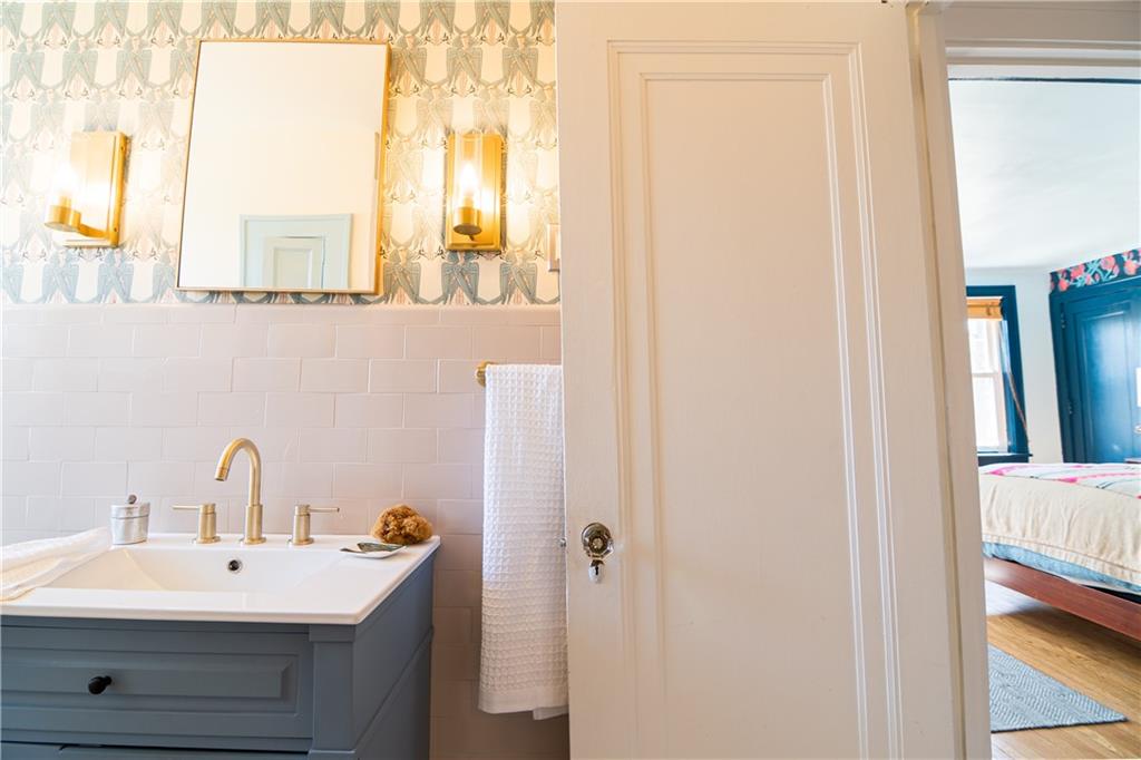 6673 Kinsman Road Pittsburgh, PA 15217 - Photo 23 of 50 a bathroom with a sink and a mirror