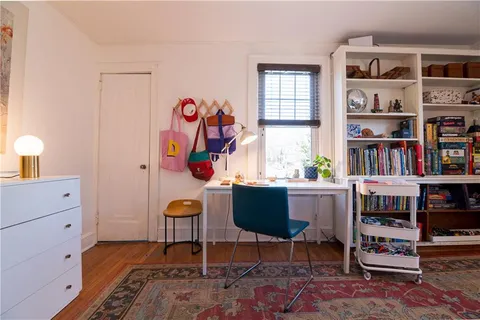 a room with bookshelf and a window