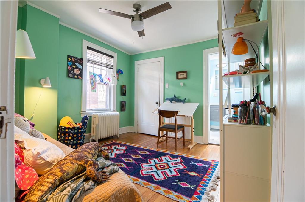 6673 Kinsman Road Pittsburgh, PA 15217 - Photo 29 of 50 a bedroom with a bed and a chandelier