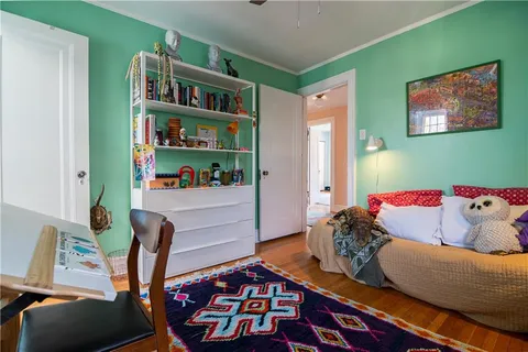 a living room with furniture and a book shelf