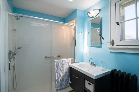 a bathroom with a sink a mirror and a shower
