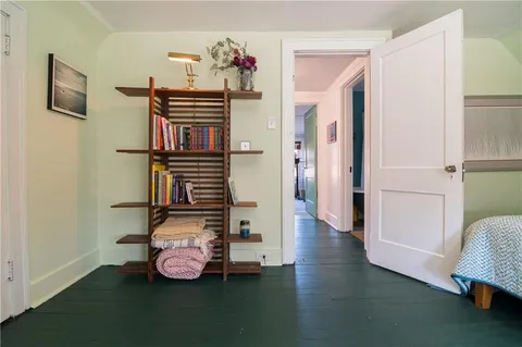 a hallway with furniture and wooden floor