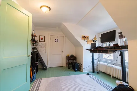 a view of a workspace with furniture and a bedroom