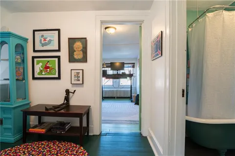 a living room with furniture and painting on the wall
