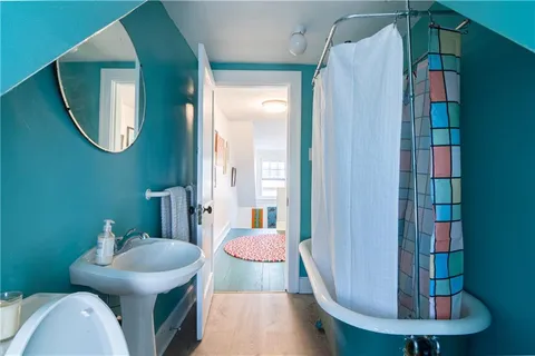 a view of a bathroom with a toilet and a mirror