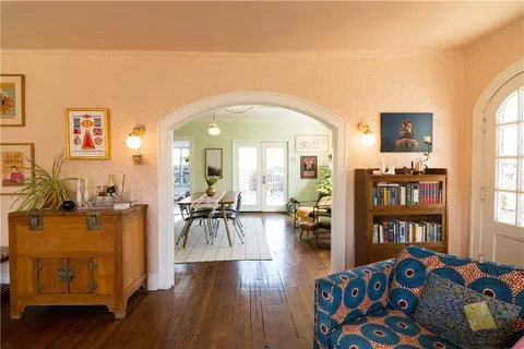 a living room with furniture and a book shelf