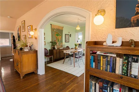 a view of a livingroom with furniture a dinning room and wooden floor