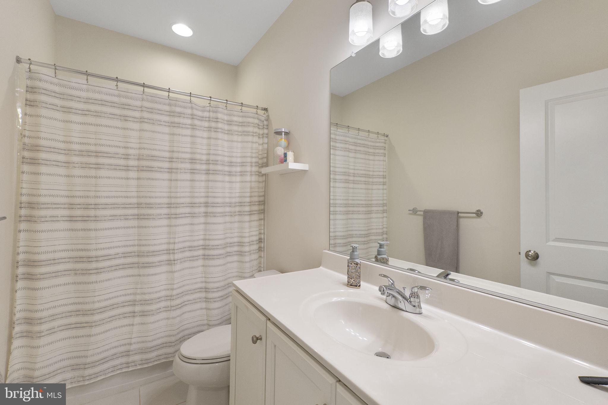 23902 Grapevine Ridge Terrace Clarksburg, MD 20871 - Photo 23 of 44 a bathroom with a sink a toilet and mirror