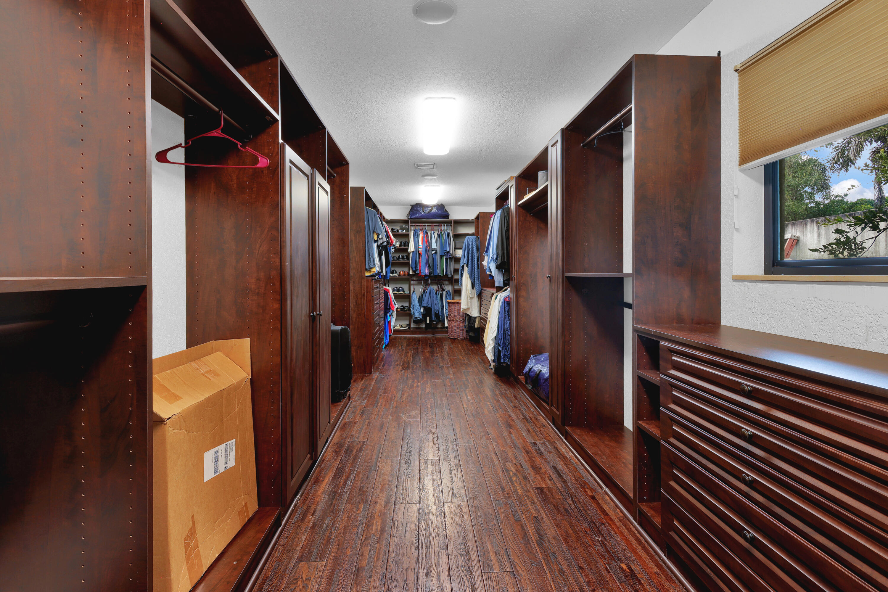 14701 Southwest 63rd Street Southwest Ranches, FL 33330 - Photo 27 of 50 a hallway with wooden floor and staircase
