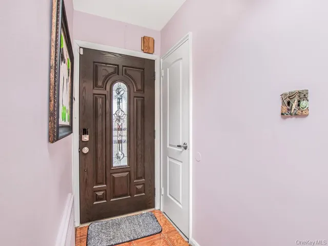 a view of front door with a mirror